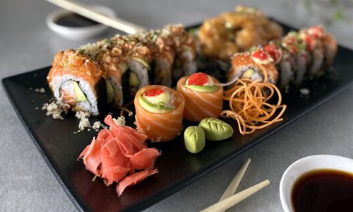 Light and crispy Tempura vegetables served on a parchment lined wooden tray.